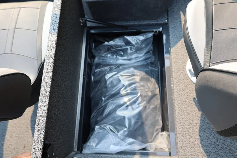 Slide: The Image of An open storage compartment in a boat's floor with a plastic cover inside. - 38