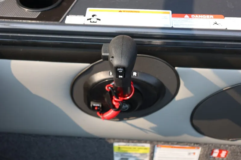 Slide: The Image of Close-up of a boat throttle lever with safety warnings and labels. - 35