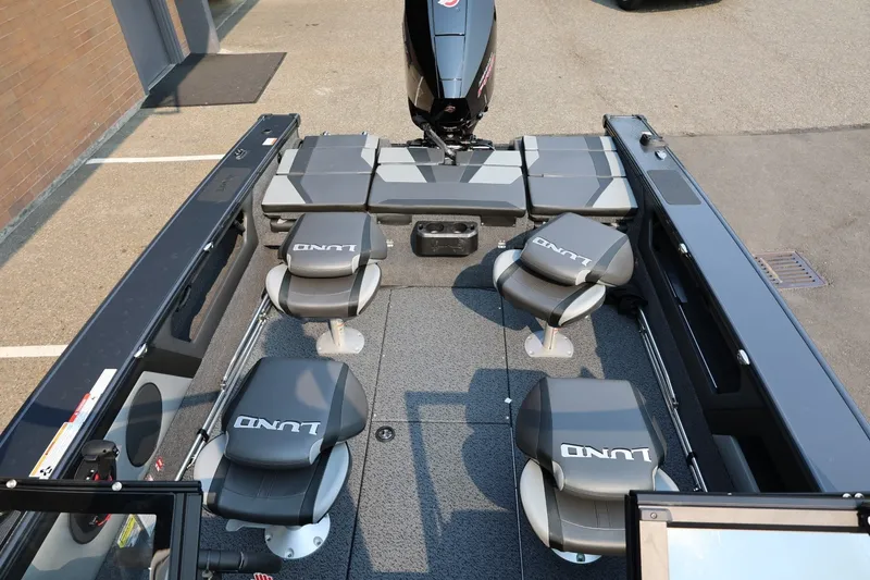 Slide: The Image of Lund 1875 Crossover XS 2027: Spacious deck with four cushioned seats and an outboard motor. - 23