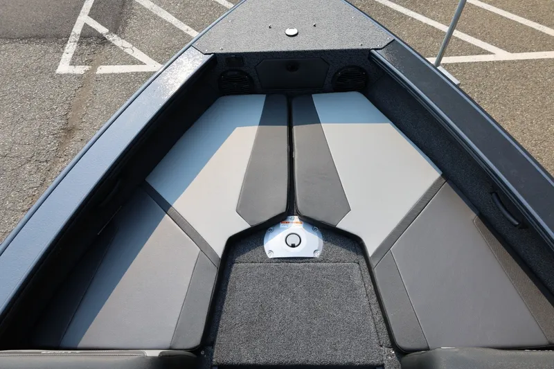 Slide: The Image of The image shows the bow of a Lund 1875 Crossover XS boat with gray upholstery. - 17