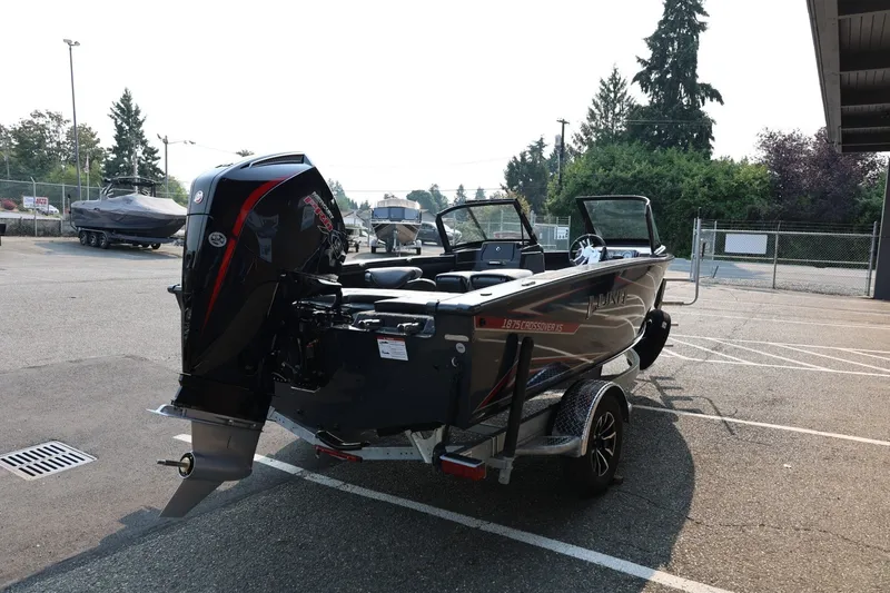 Slide: The Image of A 2027 Lund 1875 Crossover XS boat on a trailer in a parking lot. - 8