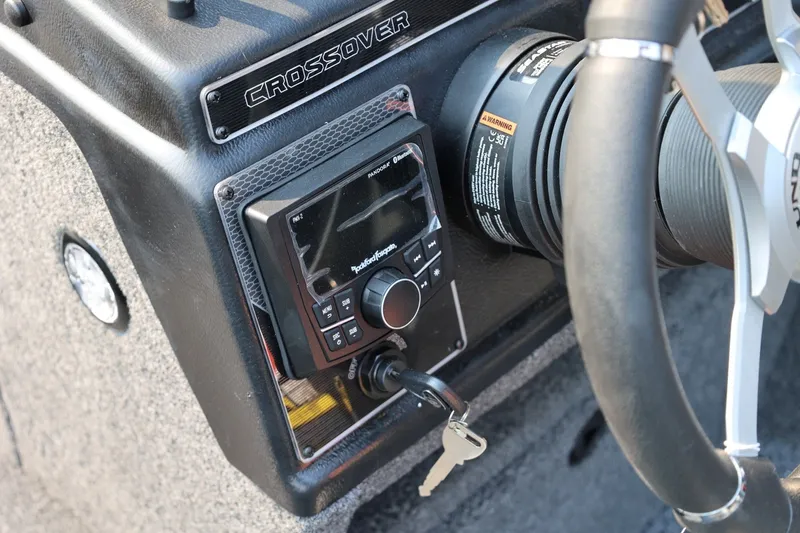 Slide: The Image of Close-up of a Lund 1875 Crossover XS boat console with controls and ignition key. - 34