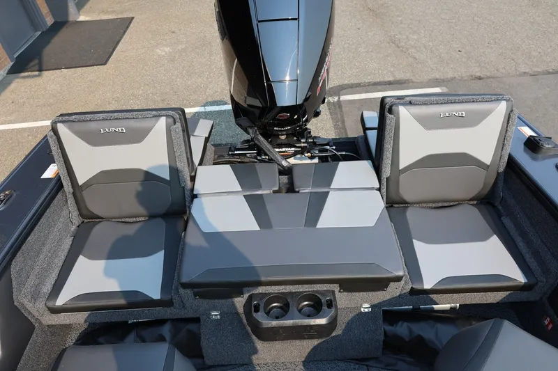 Slide: The Image of The image shows the interior of a 2027 Lund 1875 Crossover XS boat with gray seating. - 44