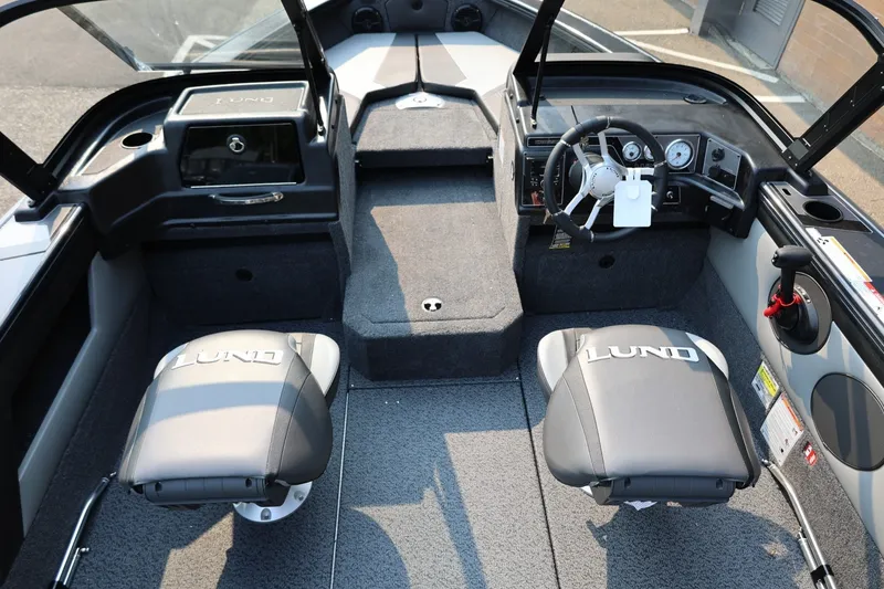 Slide: The Image of Interior view of a Lund 1875 Crossover XS boat with two cushioned seats and a modern dashboard. - 26