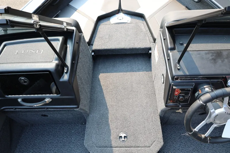 Slide: The Image of Interior view of a Lund 1875 Crossover XS boat with gray carpeting and a steering console. - 21