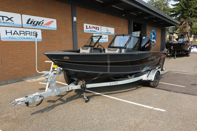 Slide: The Image of Lund 1875 Crossover XS 2027 parked on a trailer in front of a building. - 13