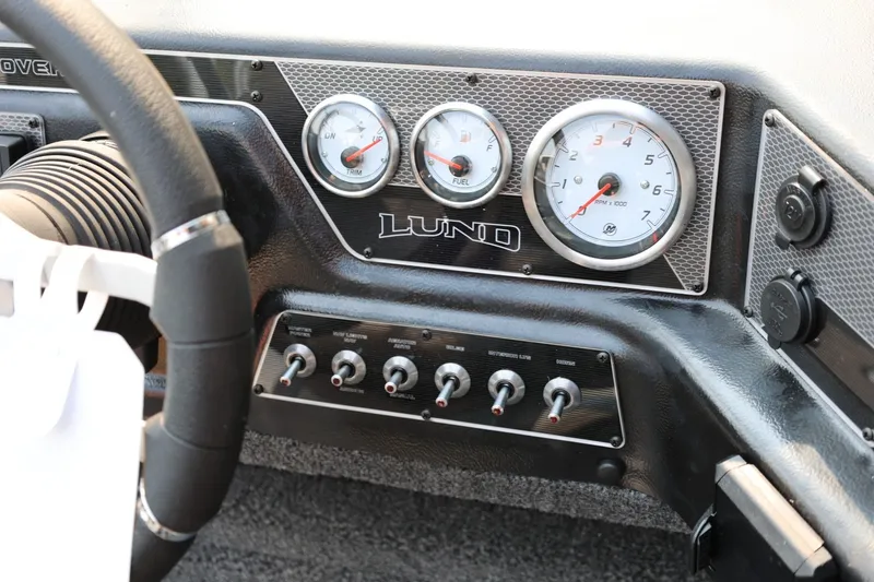 Slide: The Image of Dashboard of a Lund 1875 Crossover XS with gauges and switches. - 33