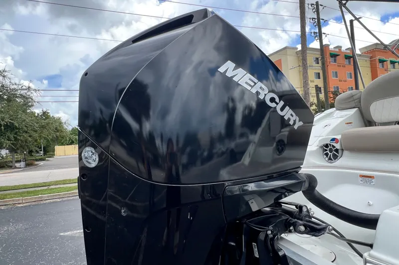 Slide: The Image of 2023 Crownline Eclipse E235 XS with Mercury outboard motor, parked outdoors. - 44