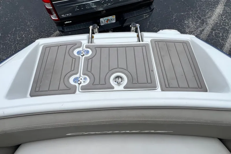 Slide: The Image of 2023 Crownline Eclipse E235 XS swim platform with textured surface and integrated ladder. - 77