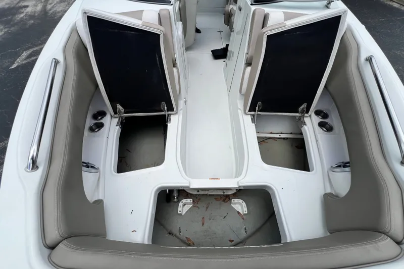 Slide: The Image of 2023 Crownline Eclipse E235 XS boat interior with open storage compartments. - 80