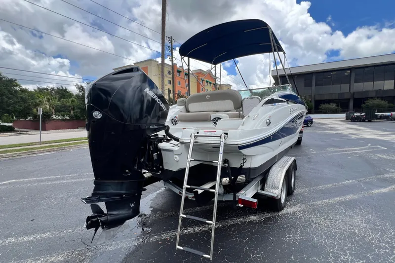Slide: The Image of 2023 Crownline Eclipse E235 XS boat with Mercury outboard engine on trailer. - 46