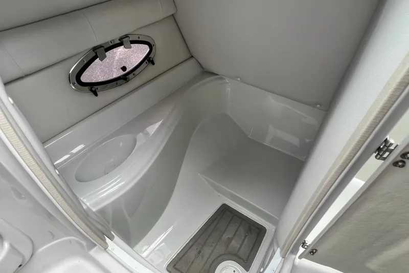 Slide: The Image of 2023 Crownline Eclipse E235 XS boat interior with porthole and seating area. - 66