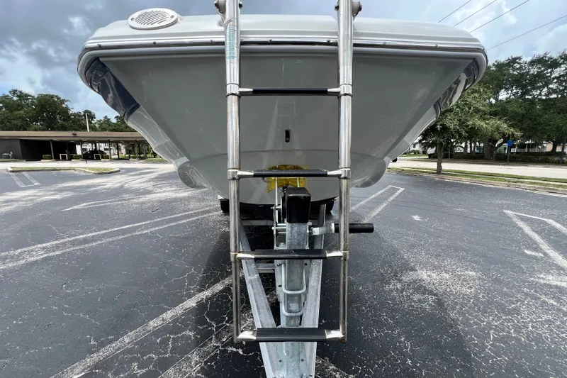 Slide: The Image of 2023 Crownline Eclipse E235 XS boat front view with ladder on trailer. - 34