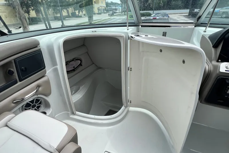 Slide: The Image of 2023 Crownline Eclipse E235 XS boat interior with open storage compartment. - 65