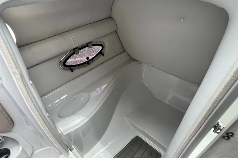 Slide: The Image of Interior of 2023 Crownline Eclipse E235 XS boat, featuring a compact cabin space. - 67