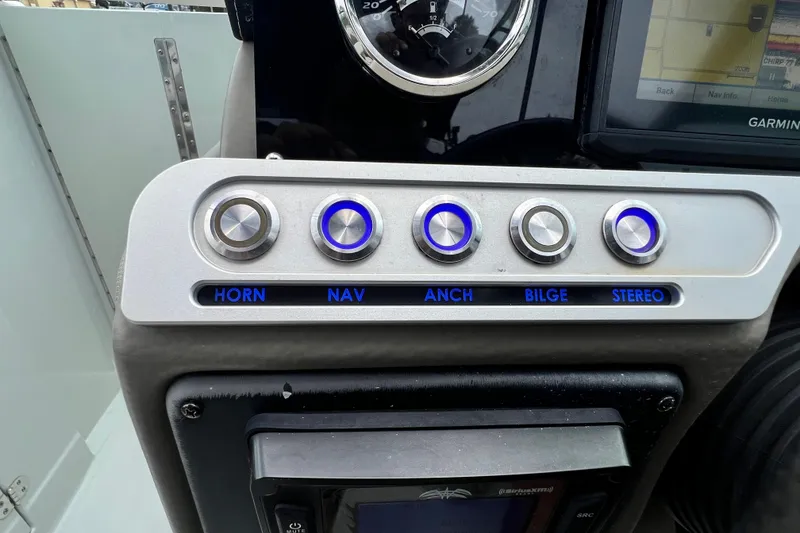Slide: The Image of Control panel of 2023 Crownline Eclipse E235 XS boat with labeled buttons. - 71