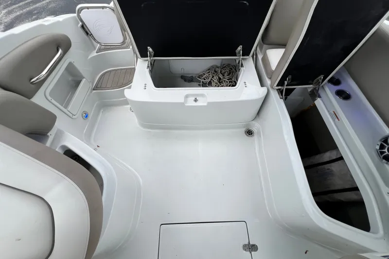 Slide: The Image of 2023 Crownline Eclipse E235 XS boat interior with storage compartments and seating. - 86