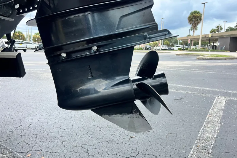 Slide: The Image of 2023 Crownline Eclipse E235 XS boat propeller in a parking lot. - 41