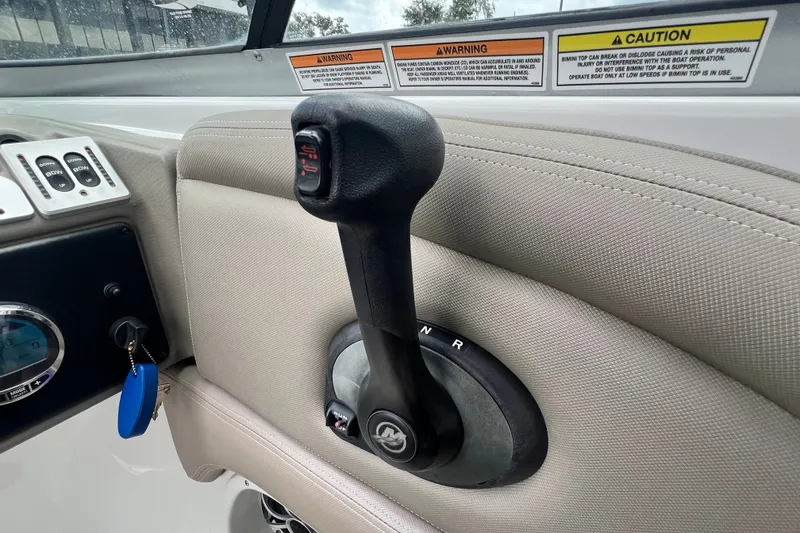 Slide: The Image of Throttle control lever on 2023 Crownline Eclipse E235 XS boat dashboard. - 73