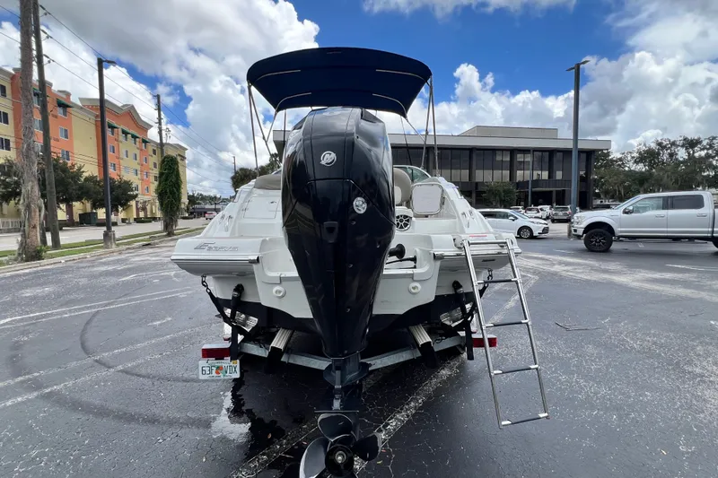 Slide: The Image of 2023 Crownline Eclipse E235 XS boat with outboard motor in a parking lot. - 47