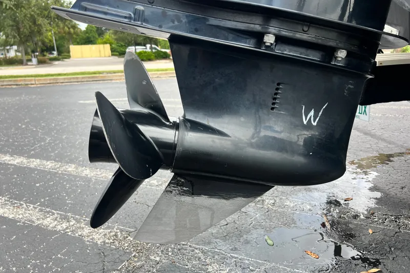 Slide: The Image of Close-up of a 2023 Crownline Eclipse E235 XS boat propeller on wet pavement. - 43