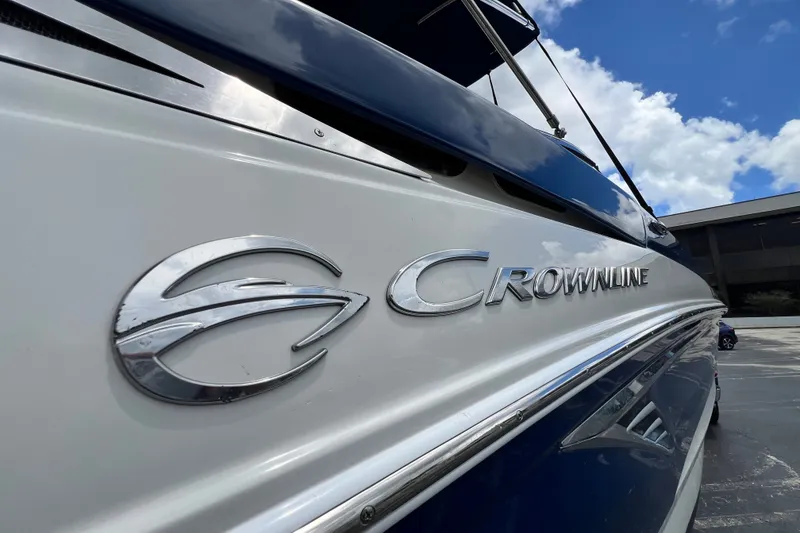 Slide: The Image of 2023 Crownline Eclipse E235 XS boat with logo, blue sky background. - 53