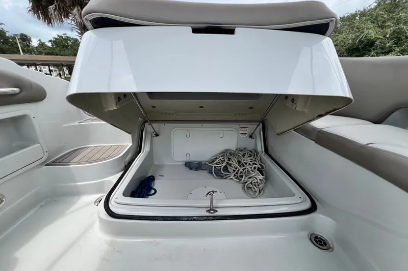 Slide: The Image of 2023 Crownline Eclipse E235 XS boat storage compartment with ropes and accessories. - 60