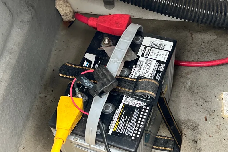Slide: The Image of Battery setup in a 2023 Crownline Eclipse E235 XS boat, featuring secure connections and wiring. - 59