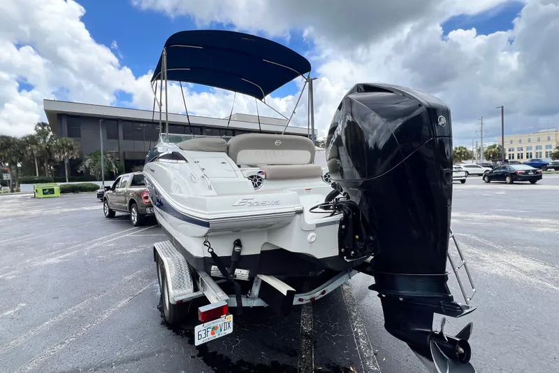 Slide: The Image of 2023 Crownline Eclipse E235 XS boat on trailer in parking lot. - 48