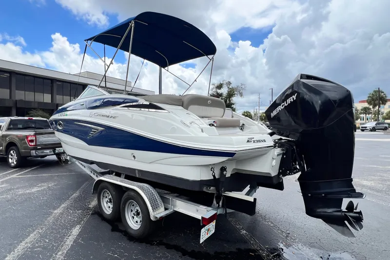 Slide: The Image of 2023 Crownline Eclipse E235 XS boat on trailer with Mercury outboard motor. - 38