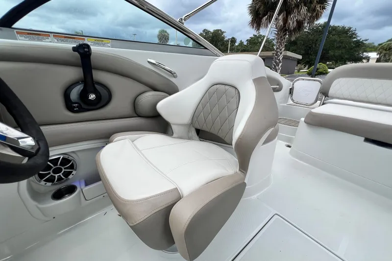 Slide: The Image of 2023 Crownline Eclipse E235 XS boat interior with plush seating and modern controls. - 83