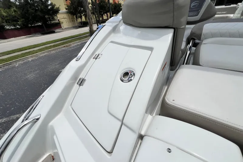 Slide: The Image of 2023 Crownline Eclipse E235 XS boat interior with seating and storage compartment. - 57