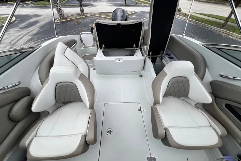Slide: The Image of 2023 Crownline Eclipse E235 XS boat interior with white and beige seating. - 85