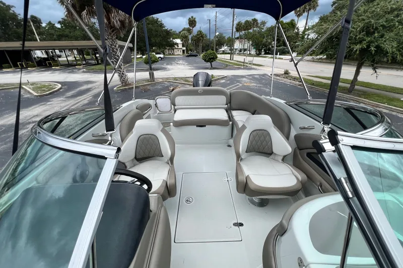 Slide: The Image of 2023 Crownline Eclipse E235 XS boat interior with luxurious seating and canopy. - 81