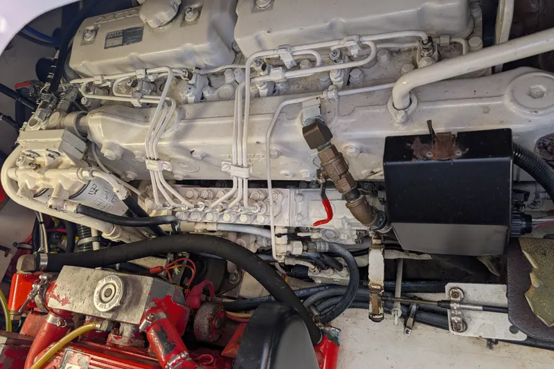 Slide: The Image of Engine compartment of a 2000 Pursuit 3400 Express boat, showcasing mechanical components. - 36