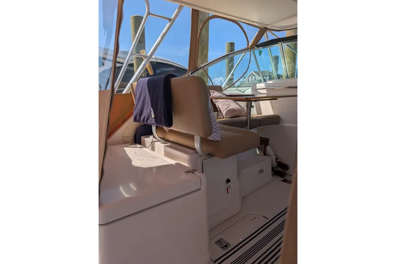 Slide: The Image of Interior of a 2000 Pursuit 3400 Express boat with seating and table. - 21