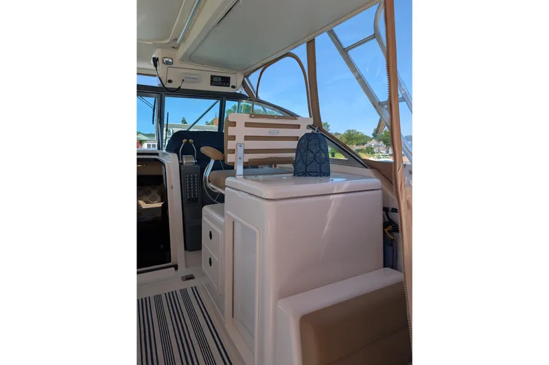 Slide: The Image of Interior view of a 2000 Pursuit 3400 Express boat, featuring helm and seating area. - 20