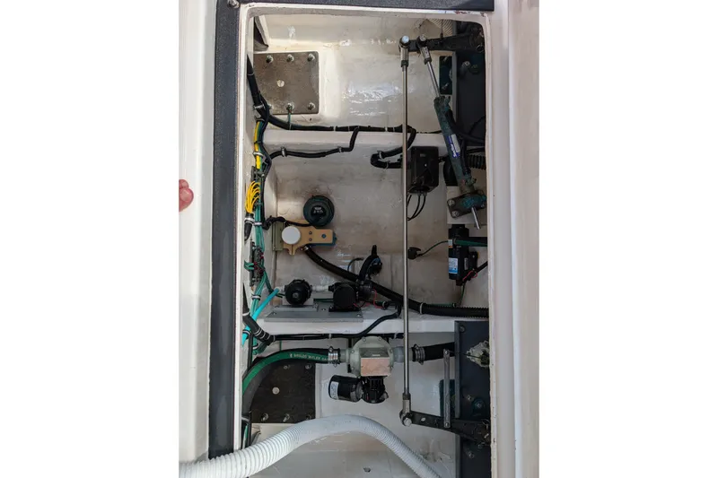Slide: The Image of Engine compartment of a 2000 Pursuit 3400 Express boat, showing wiring and mechanical components. - 44