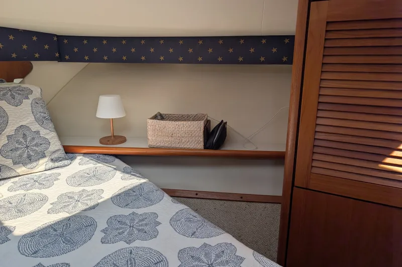 Slide: The Image of Cozy cabin interior of 2000 Pursuit 3400 Express with nautical decor and wooden accents. - 7