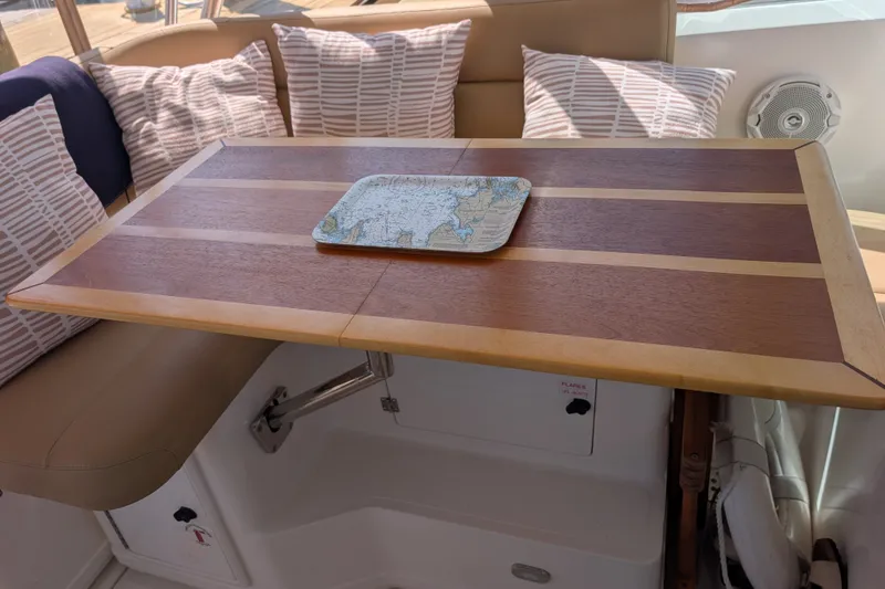 Slide: The Image of Wooden table with nautical map tray on a 2000 Pursuit 3400 Express boat. - 38