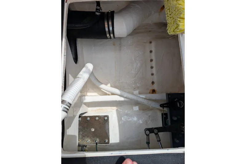Slide: The Image of Engine compartment of a 2000 Pursuit 3400 Express boat, showing hoses and fittings. - 45