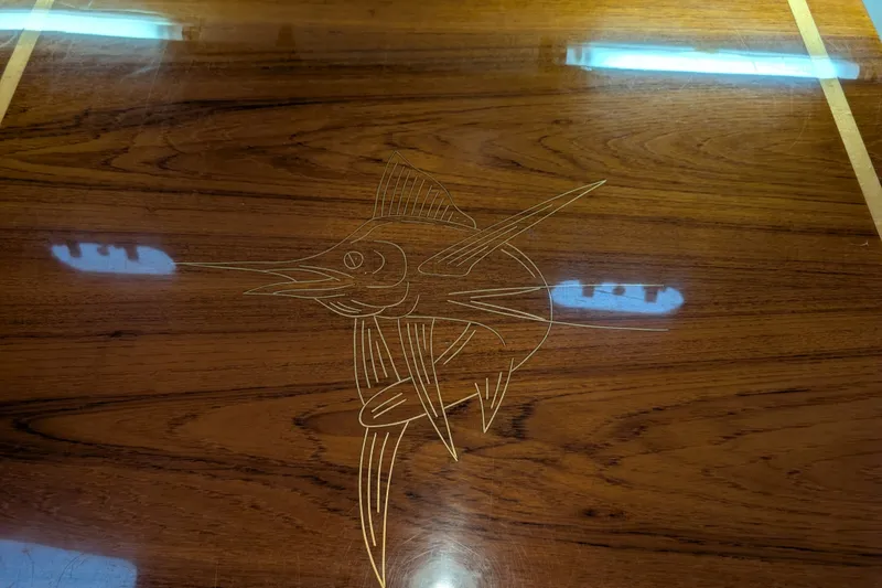 Slide: The Image of Wooden surface with marlin engraving on a 2000 Pursuit 3400 Express boat. - 53