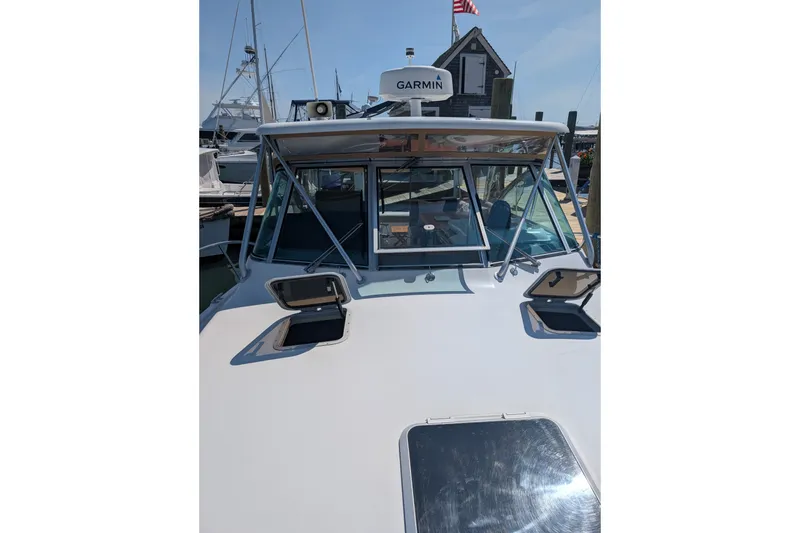 Slide: The Image of 2000 Pursuit 3400 Express boat with Garmin equipment at a marina. - 28