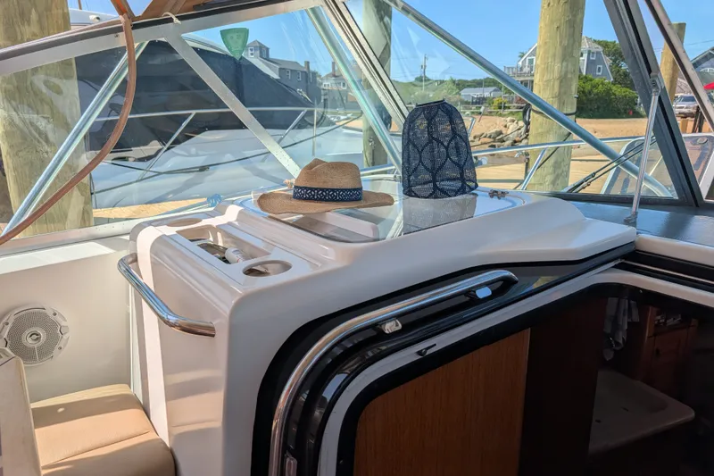 Slide: The Image of Interior of a 2000 Pursuit 3400 Express boat with a hat and lantern. - 17