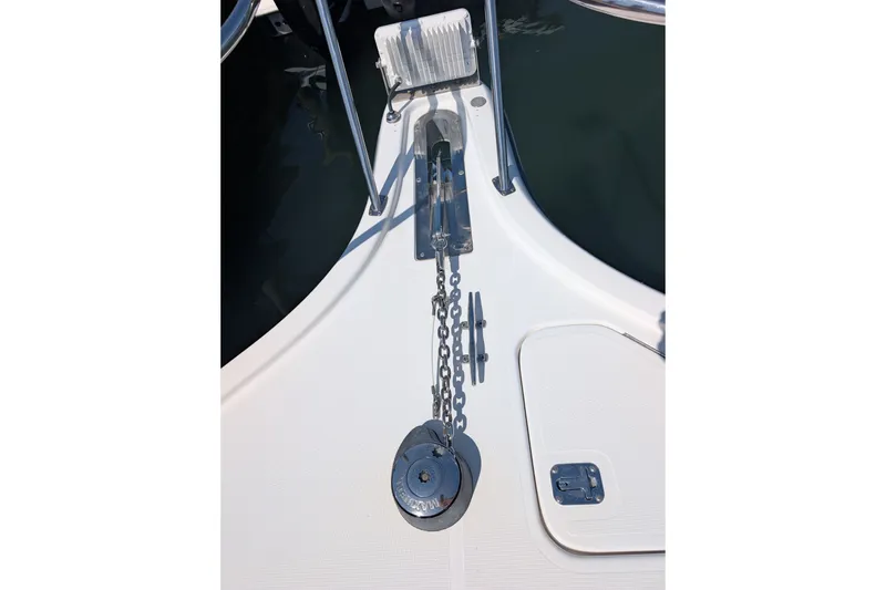 Slide: The Image of Anchor chain and deck of 2000 Pursuit 3400 Express boat, featuring marine hardware. - 27