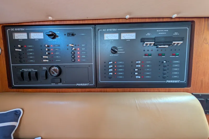 Slide: The Image of Control panel of a 2000 Pursuit 3400 Express boat, featuring DC and AC systems. - 12