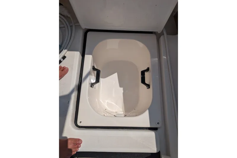 Slide: The Image of Open storage compartment on 2000 Pursuit 3400 Express boat deck. - 46