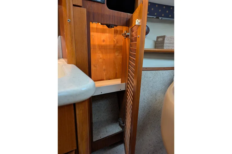 Slide: The Image of Wooden cabinet interior on a 2000 Pursuit 3400 Express boat. - 49