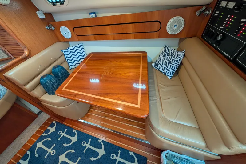 Slide: The Image of Luxurious interior of a 2000 Pursuit 3400 Express yacht with plush seating and wooden table. - 54