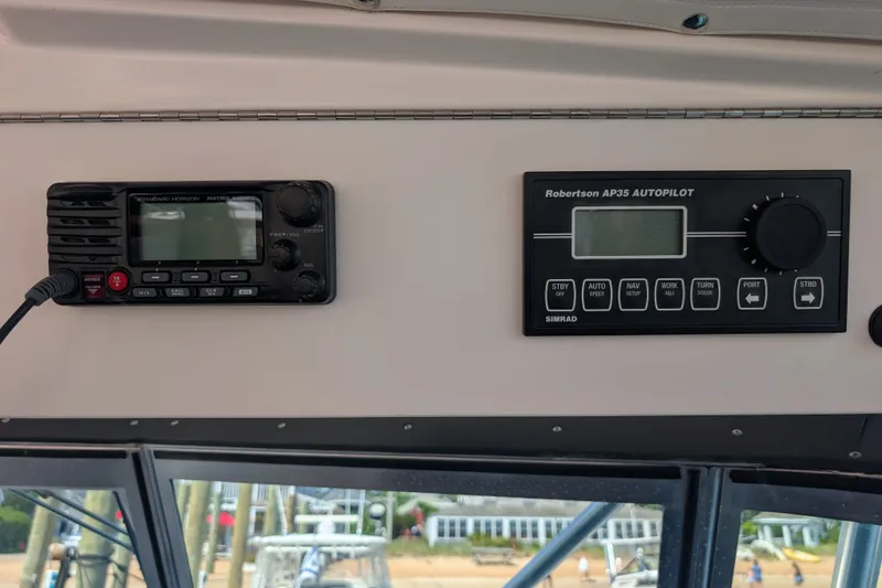 Slide: The Image of Control panel of a 2000 Pursuit 3400 Express boat with radio and autopilot systems. - 33